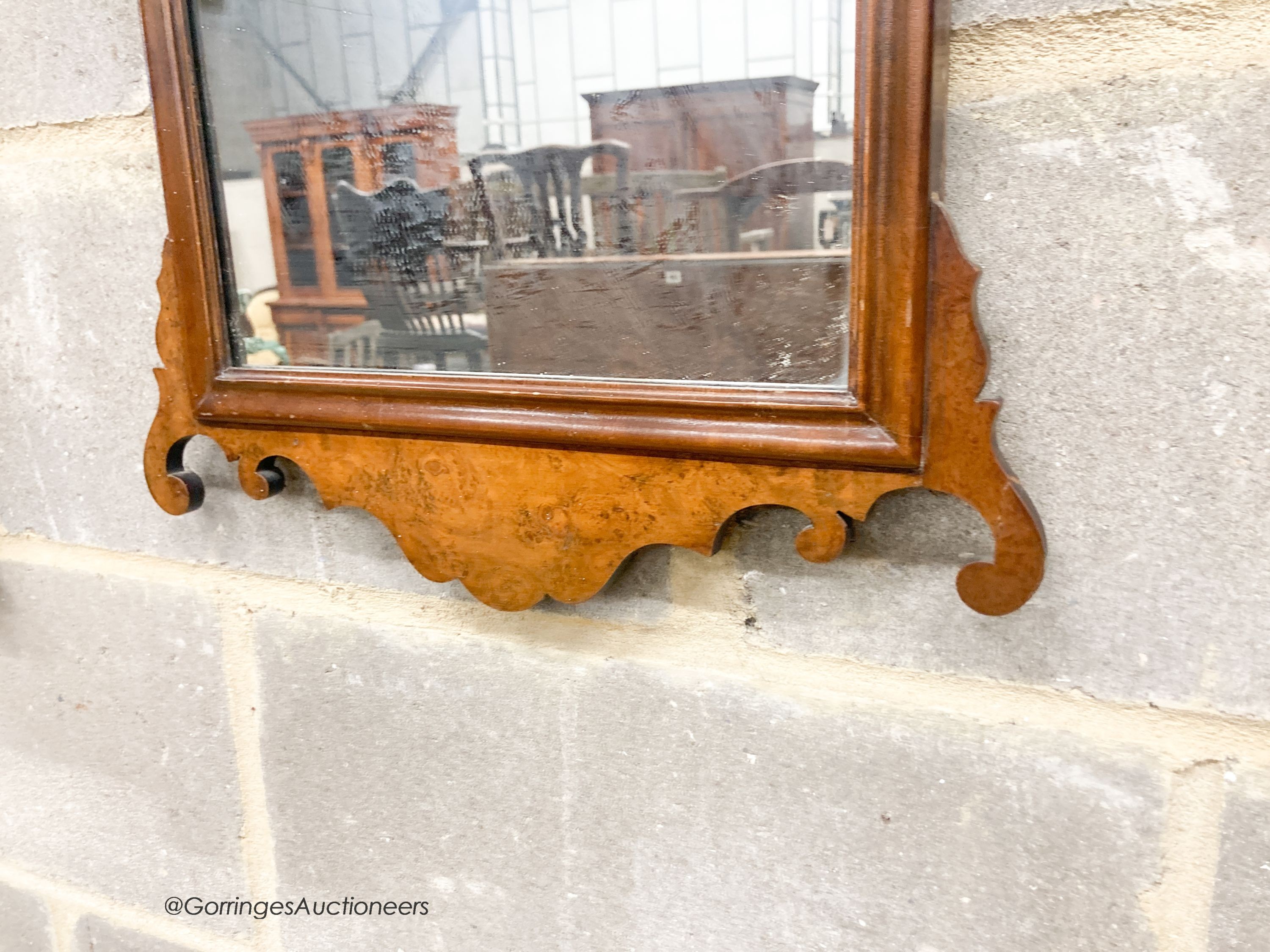 A pair of 18th century style walnut fret cut wall mirrors, width 42cm, height 70cm